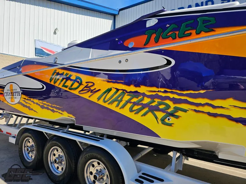 Slide: The Image of 2003 Cigarette 42 Tiger boat with vibrant "Wild by Nature" graphics on trailer. - 5