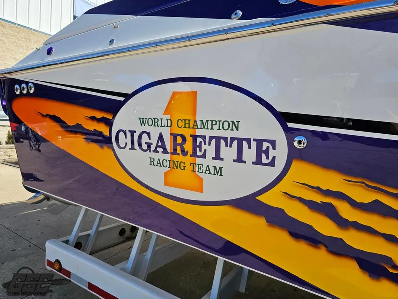 Slide: The Image of 2003 Cigarette 42 Tiger boat with vibrant racing team graphics. - 6