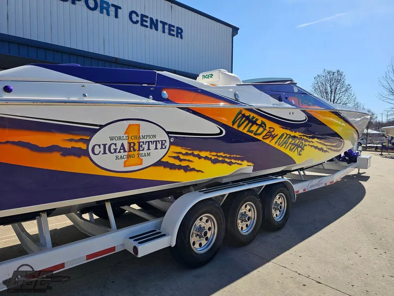 Slide: The Image of 2003 Cigarette 42 Tiger speedboat with vibrant graphics on a trailer. - 7