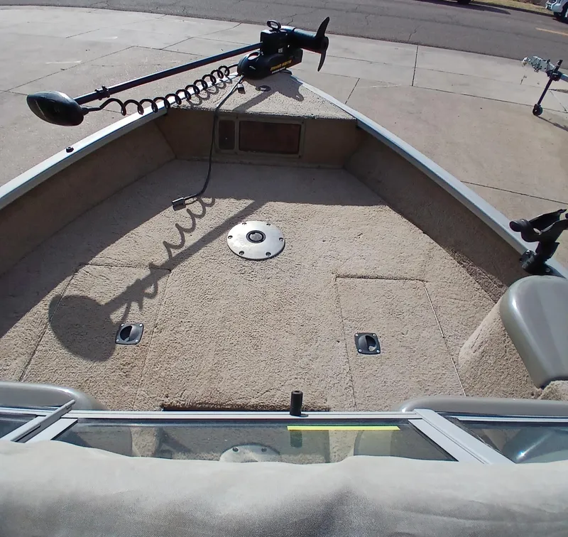 Slide: The Image of 2005 Tracker Targa V17 boat interior with trolling motor and carpeted deck. - 2