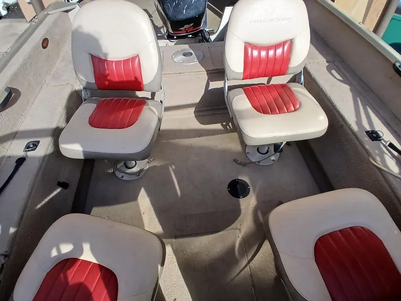 Slide: The Image of 2005 Tracker Targa V17 boat interior with four red and white seats. - 3