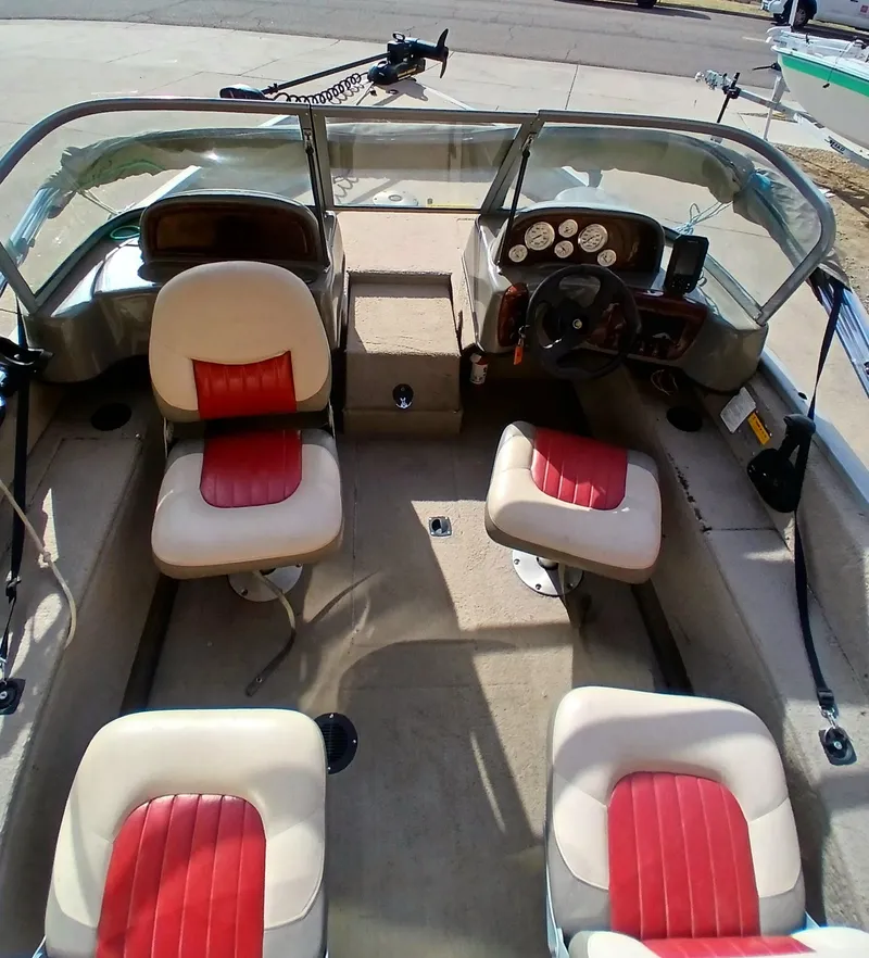 Slide: The Image of 2005 Tracker Targa V17 boat interior with red and white seats, steering wheel, and dashboard. - 4