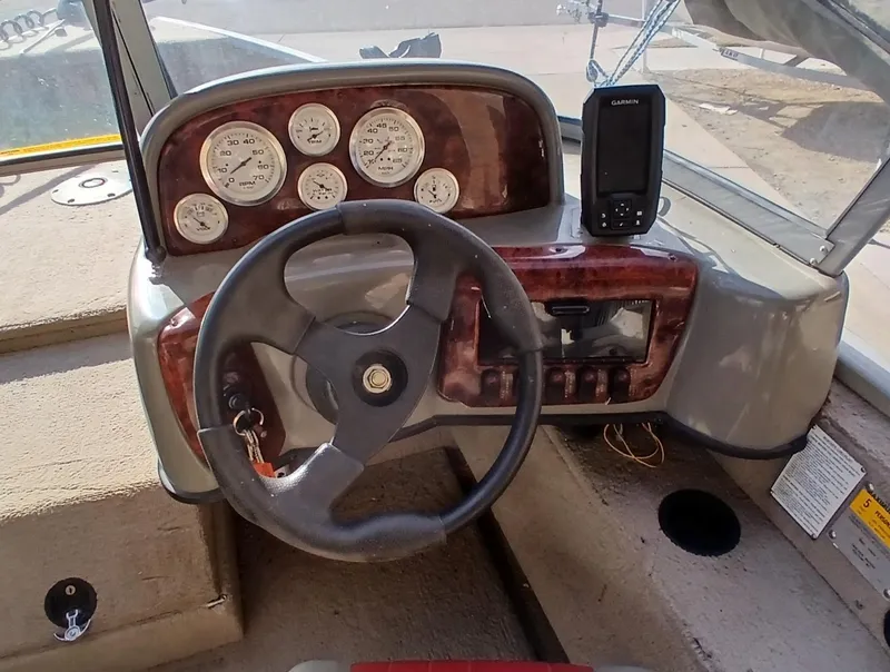 Slide: The Image of 2005 Tracker Targa V17 boat dashboard with steering wheel and gauges. - 5