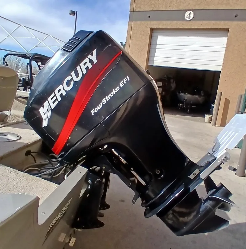 Slide: The Image of 2005 Tracker Targa V17 with Mercury FourStroke EFI outboard motor in a garage setting. - 6