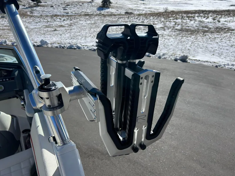 Slide: The Image of 2020 Cobalt R5 Surf boat with a mounted wakeboard rack in snowy landscape. - 10