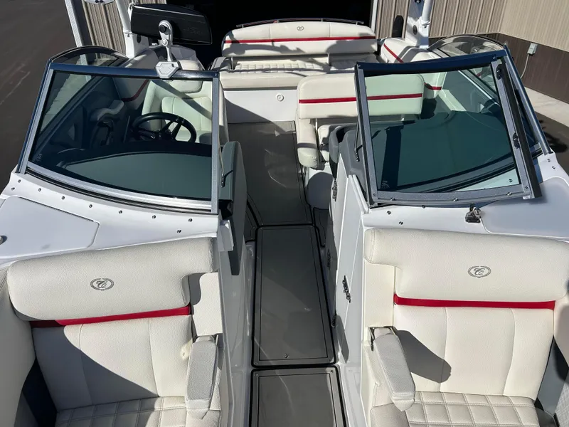 Slide: The Image of 2020 Cobalt R5 Surf boat interior with white and red seating, open windshield, and steering wheel. - 17