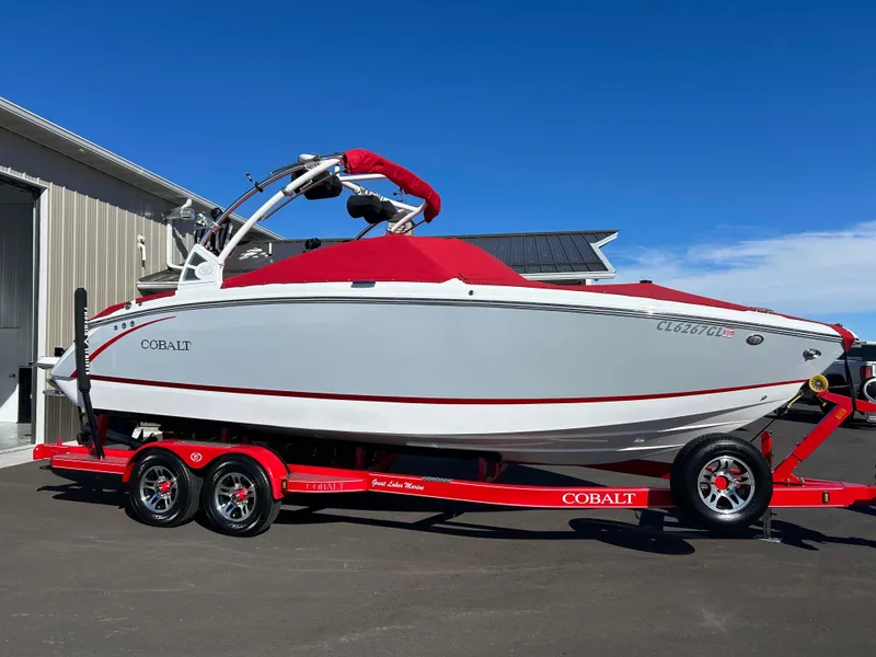 Slide: The Image of 2020 Cobalt R5 Surf boat on red trailer, parked outdoors. - 3