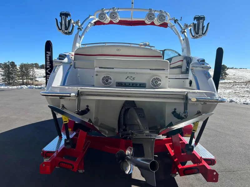 Slide: The Image of 2020 Cobalt R5 Surf boat on red trailer, rear view, outdoor setting. - 6