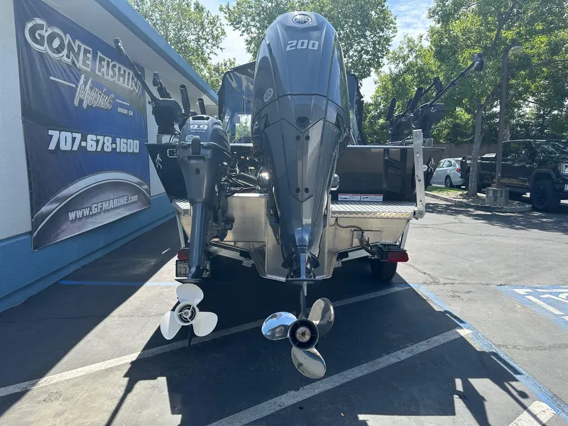 Slide: The Image of 2025 Duckworth 20 Advantage boat with dual outboard motors in a parking lot. - 2