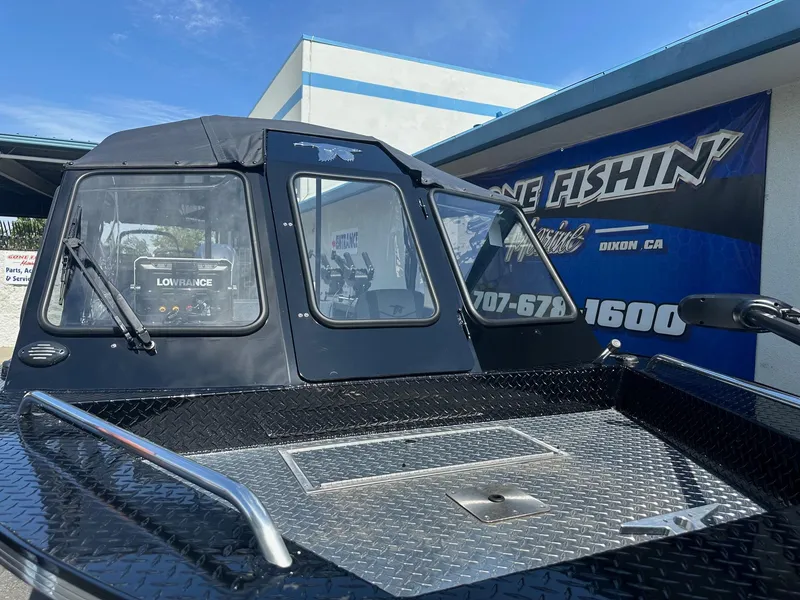 Slide: The Image of 2025 Duckworth 20 Advantage boat with black cabin, displayed outdoors. - 3