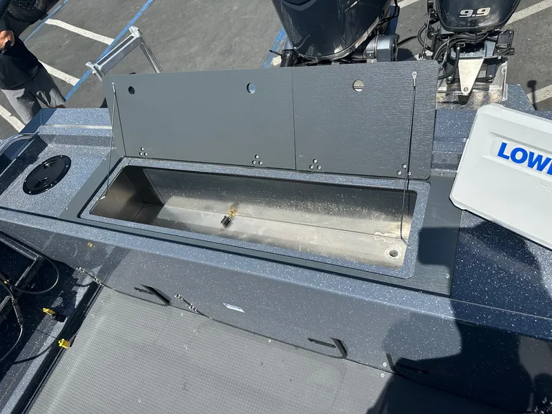 Slide: The Image of 2025 Duckworth 20 Advantage boat with open storage compartment and Lowrance equipment. - 8