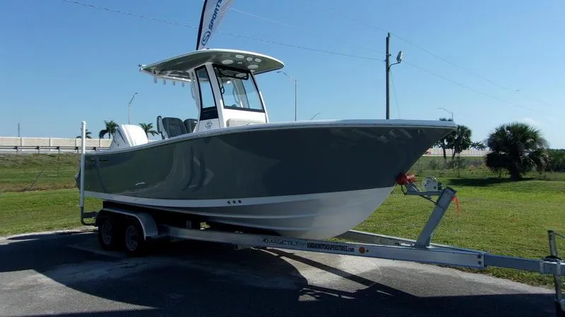 Slide: The Image of 2025 Sportsman Open 232 boat on trailer, parked outdoors under clear sky. - 0