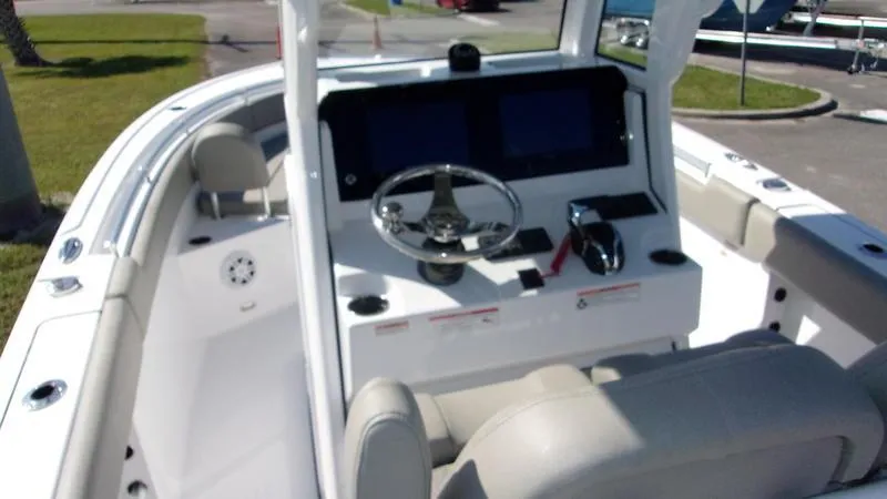 Slide: The Image of 2025 Sportsman Open 232 boat interior with steering console and seating. - 5