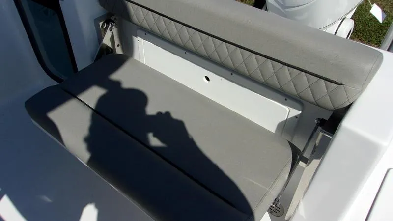 Slide: The Image of 2025 Sportsman Open 232 boat seat with gray upholstery and diamond stitching. - 6