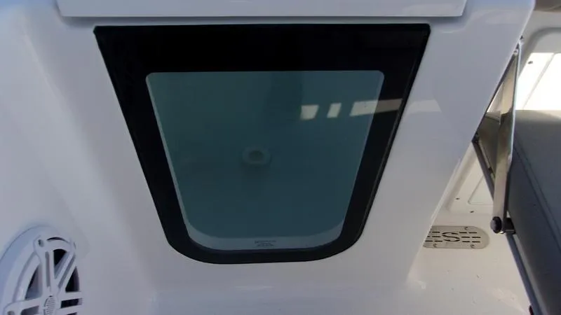 Slide: The Image of 2025 Sportsman Open 232 boat interior detail with speaker and storage compartment. - 7