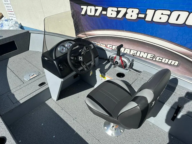 Slide: The Image of 2025 Lund 1400 Fury SS boat interior with steering console and seating. - 11