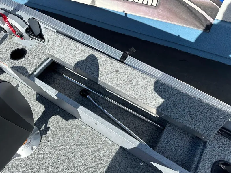 Slide: The Image of 2025 Lund 1400 Fury SS boat interior with storage compartment and seating. - 13