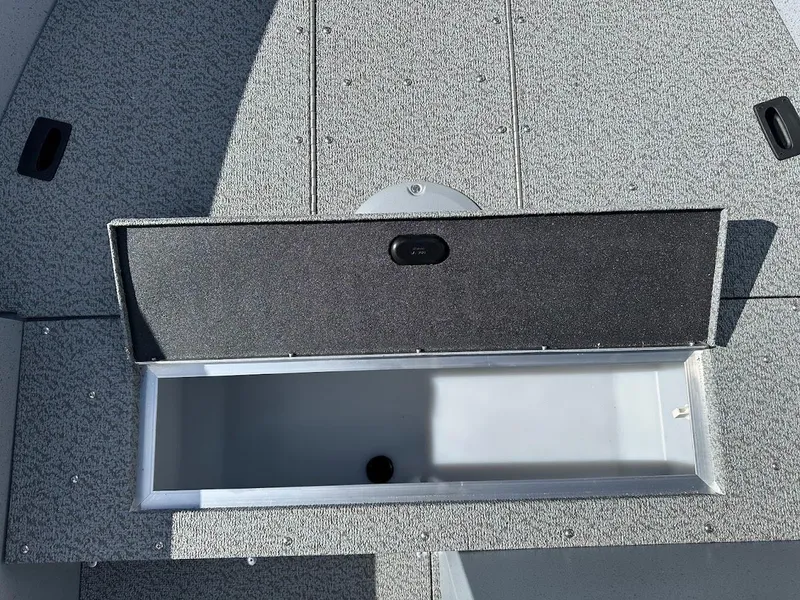 Slide: The Image of 2025 Lund 1400 Fury SS boat storage compartment, open and empty. - 15