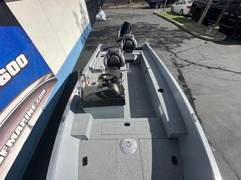 Slide: The Image of 2025 Lund 1400 Fury SS boat, gray interior, parked outdoors. - 8