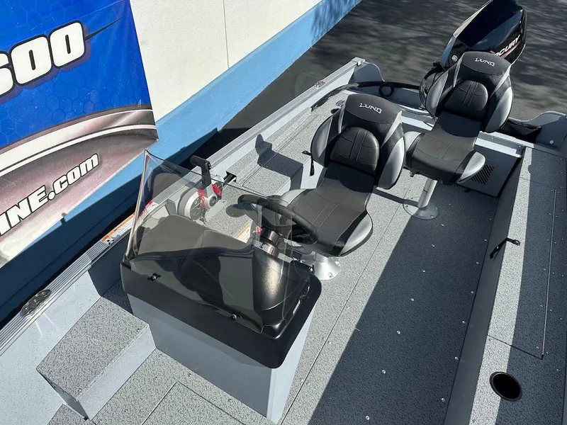 Slide: The Image of 2025 Lund 1400 Fury SS boat interior with two seats and steering console. - 9