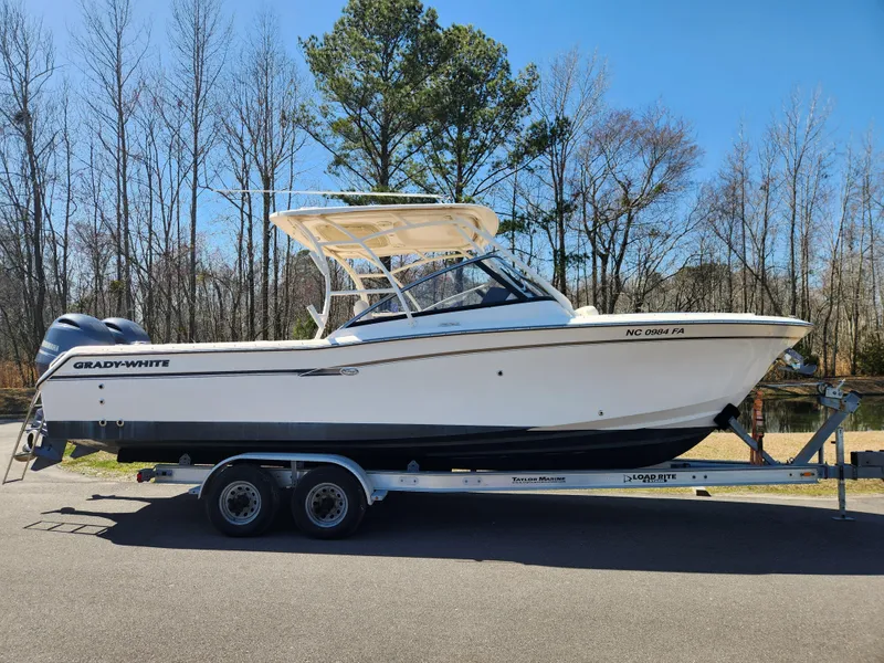 The Image of 2015 Grady-White Freedom 275 boat on trailer, parked outdoors. - 0