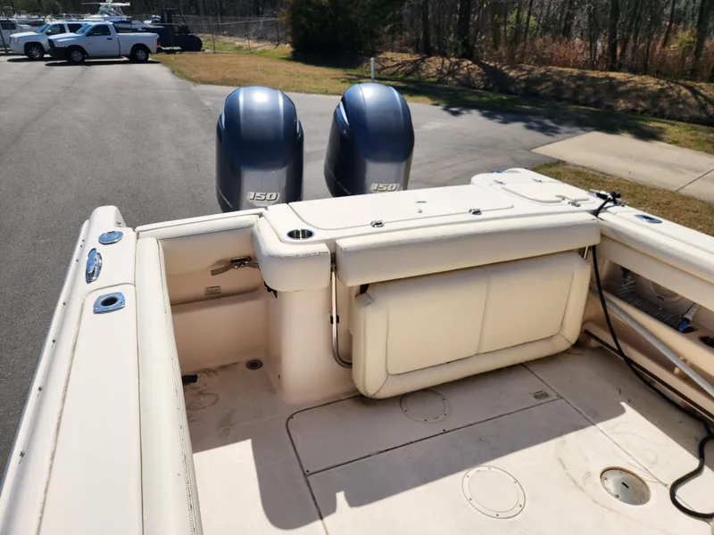 Slide: The Image of 2015 Grady-White Freedom 275 boat with twin 250 engines, parked outdoors. - 14