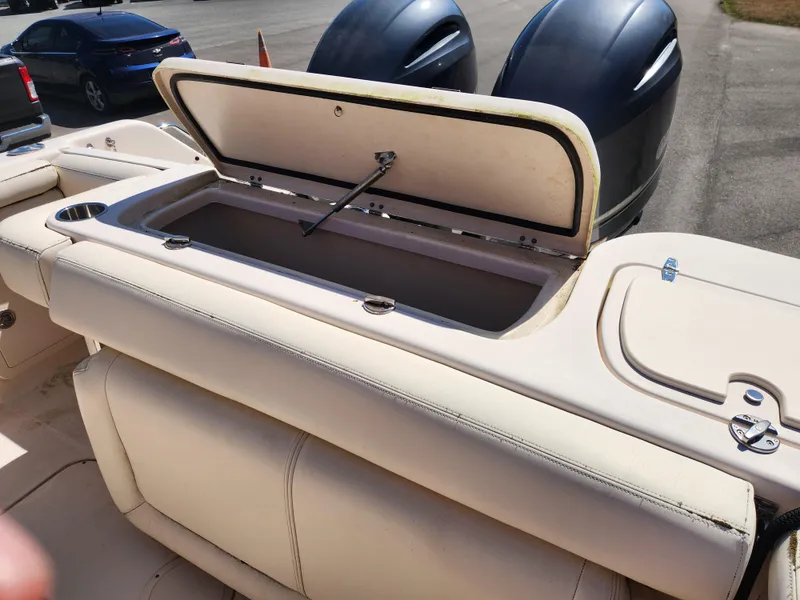 Slide: The Image of 2015 Grady-White Freedom 275 boat with open storage compartment and dual engines. - 16