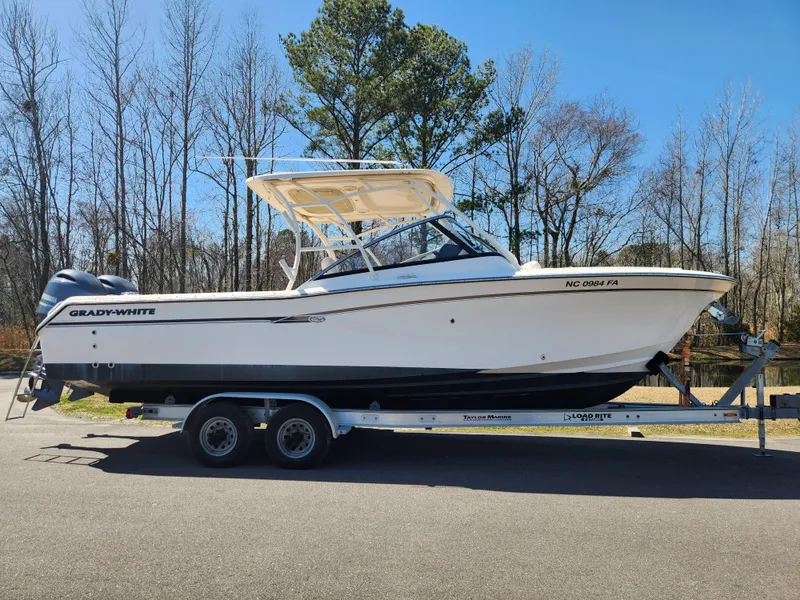 Slide: The Image of 2015 Grady-White Freedom 275 boat on trailer, parked outdoors. - 19
