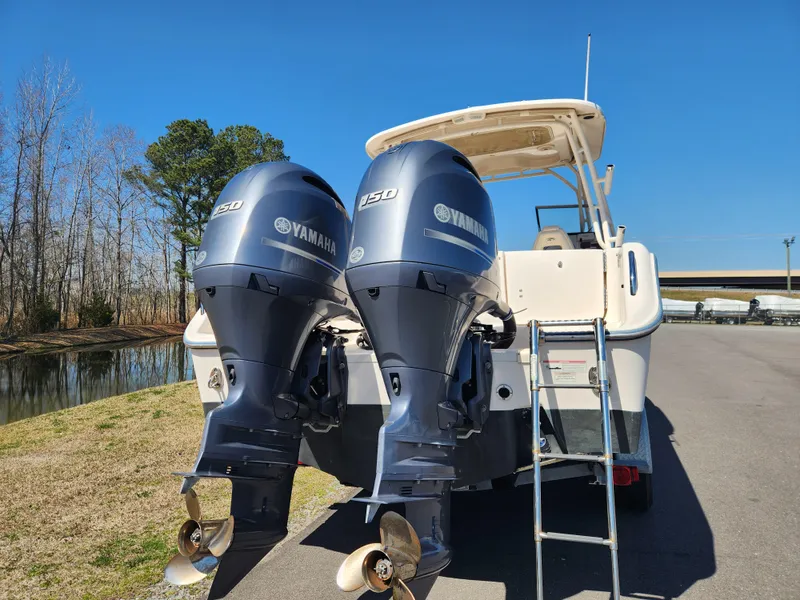 Slide: The Image of 2015 Grady-White Freedom 275 boat with twin Yamaha 350 engines, parked near water. - 3