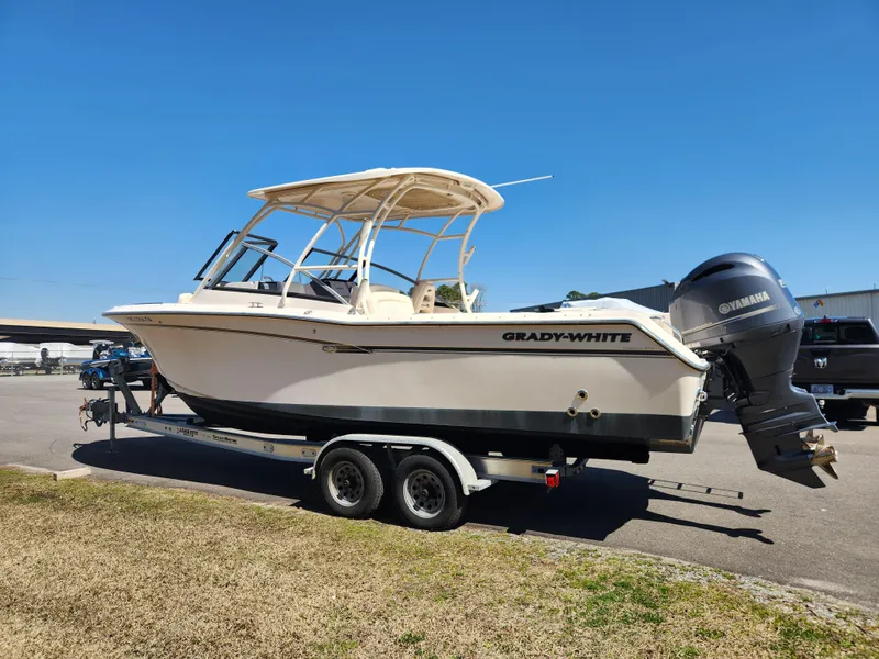 Slide: The Image of 2015 Grady-White Freedom 275 boat on trailer with Yamaha engine, parked outdoors. - 5