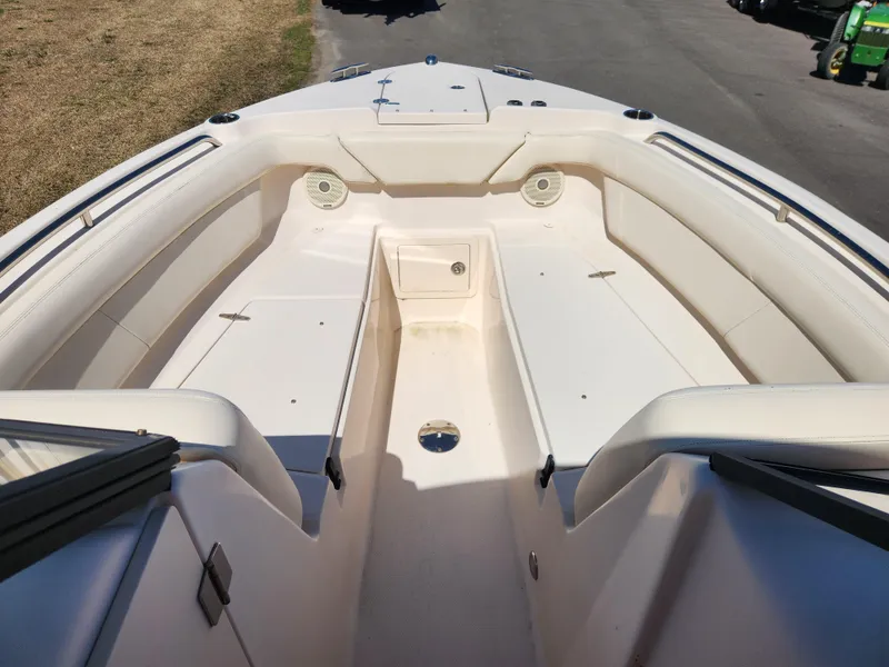 Slide: The Image of 2015 Grady-White Freedom 275 boat interior, spacious seating, clean design, white upholstery. - 8