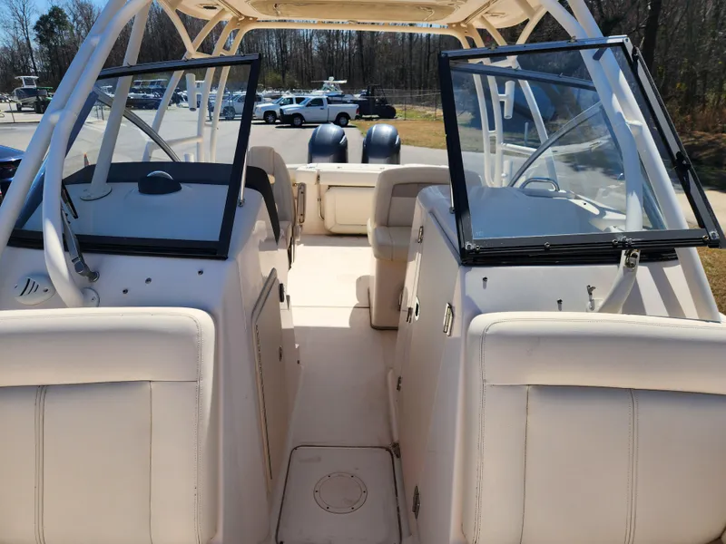 Slide: The Image of 2015 Grady-White Freedom 275 boat interior with open windshield and seating. - 9