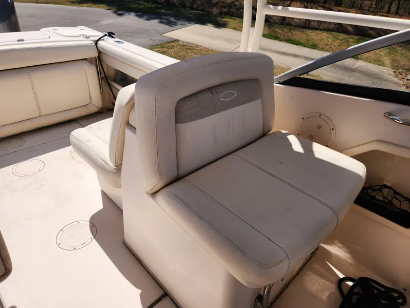 Slide: The Image of 2015 Grady-White Freedom 275 boat interior with beige seating and deck view. - 12
