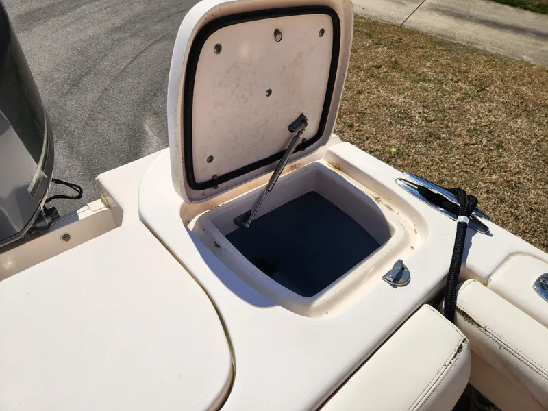 Slide: The Image of 2015 Grady-White Freedom 275 boat storage compartment open, showing interior details. - 17