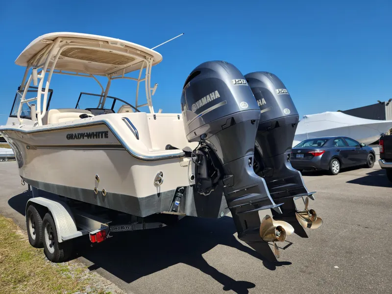 Slide: The Image of 2015 Grady-White Freedom 275 boat with twin Yamaha engines on a trailer. - 4