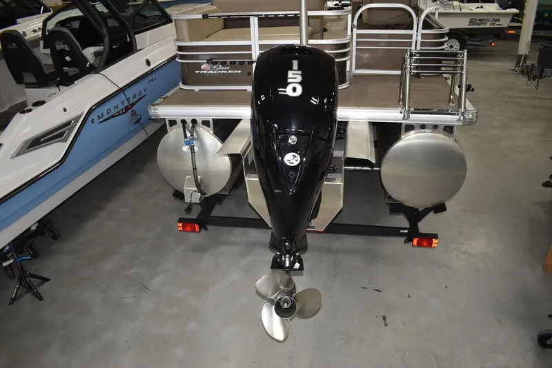 Slide: The Image of 2023 Sun Tracker Sportfish™ 24 XP3 pontoon boat with powerful 150 HP outboard motor. - 11