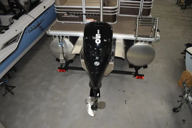 Slide: The Image of 2023 Sun Tracker Sportfish™ 24 XP3 pontoon boat with 150 HP outboard motor. - 12