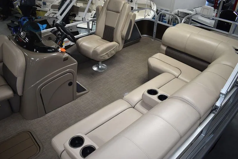 Slide: The Image of 2023 Sun Tracker Sportfish™ 24 XP3 interior with beige seating and modern helm. - 20