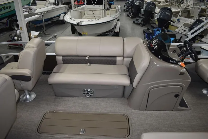 Slide: The Image of 2023 Sun Tracker Sportfish™ 24 XP3 interior with beige seating and steering console. - 22
