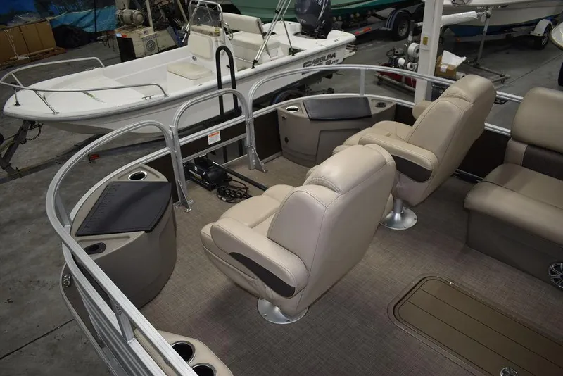 Slide: The Image of 2023 Sun Tracker Sportfish™ 24 XP3 pontoon boat interior with beige seating and cup holders. - 23