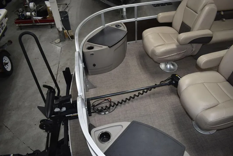 Slide: The Image of 2023 Sun Tracker Sportfish™ 24 XP3 interior with beige seating and fishing equipment. - 24