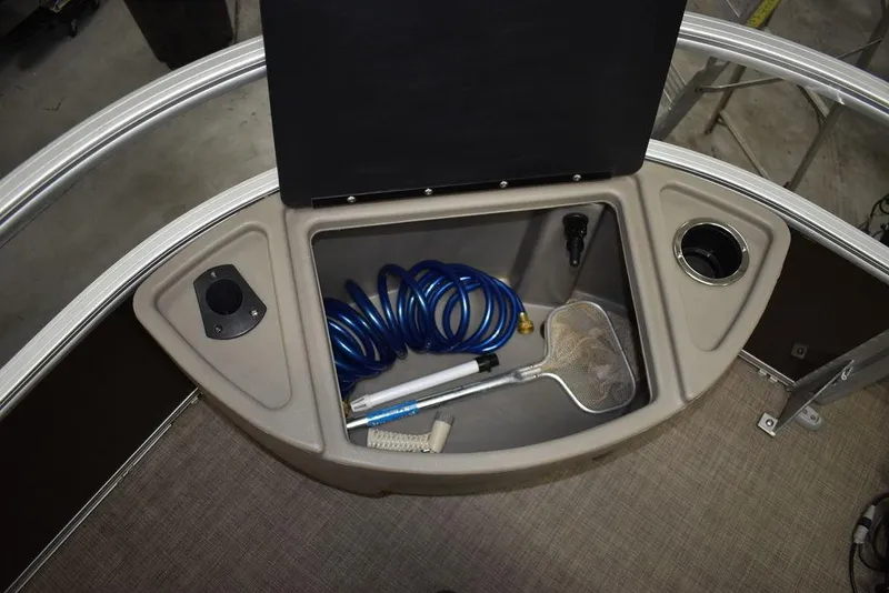 Slide: The Image of 2023 Sun Tracker Sportfish™ 24 XP3 storage compartment with hose and net. - 32