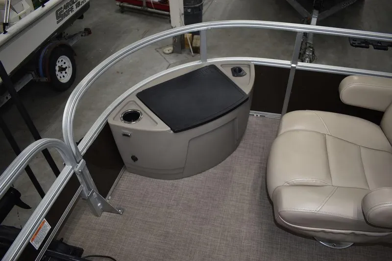 Slide: The Image of 2023 Sun Tracker Sportfish™ 24 XP3 boat interior with seating and storage area. - 33
