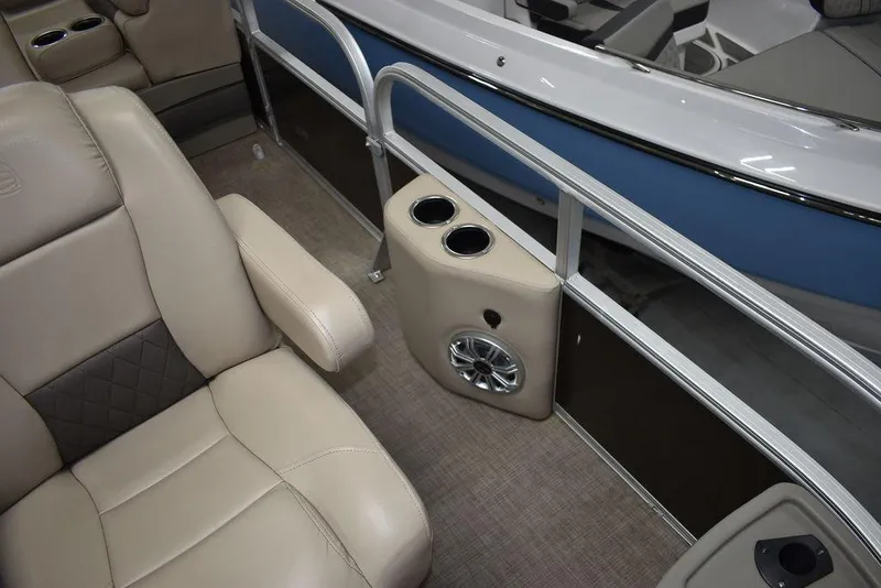 Slide: The Image of 2023 Sun Tracker Sportfish™ 24 XP3 interior with beige seating, cup holders, and speaker. - 35