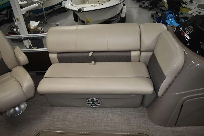 Slide: The Image of 2023 Sun Tracker Sportfish™ 24 XP3 boat interior with beige seating and speaker. - 39