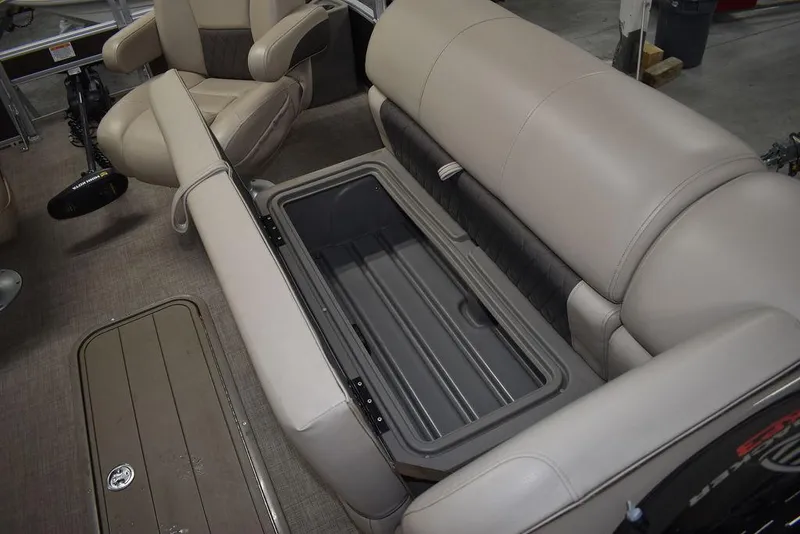 Slide: The Image of 2023 Sun Tracker Sportfish™ 24 XP3 boat interior with open storage compartment and beige seating. - 40