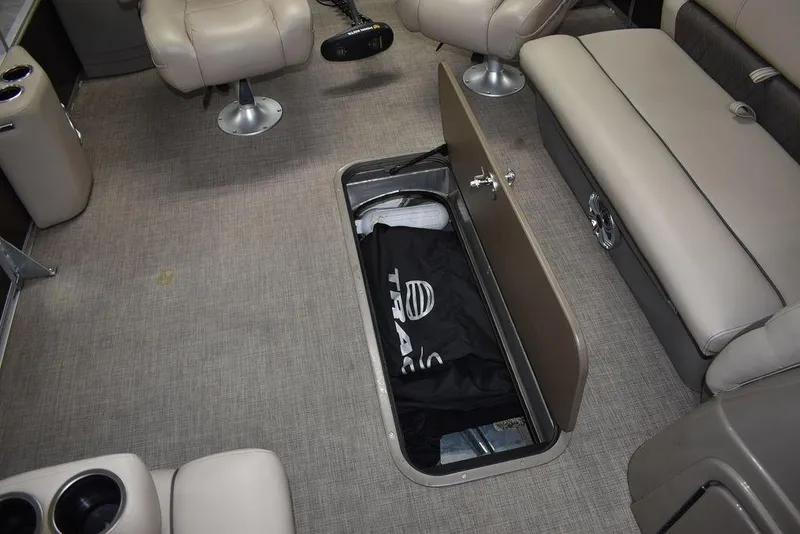 Slide: The Image of 2023 Sun Tracker Sportfish™ 24 XP3 interior with open storage compartment and seating. - 42