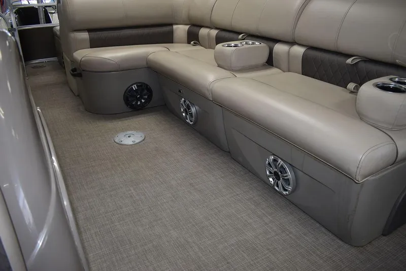 Slide: The Image of 2023 Sun Tracker Sportfish™ 24 XP3 interior with beige seating and built-in speakers. - 44