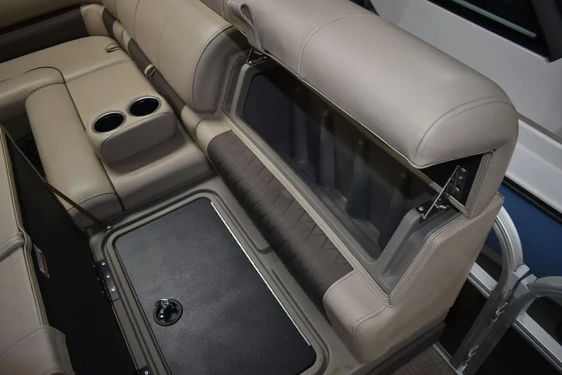 Slide: The Image of 2023 Sun Tracker Sportfish™ 24 XP3 boat interior with beige seating and storage compartment. - 48