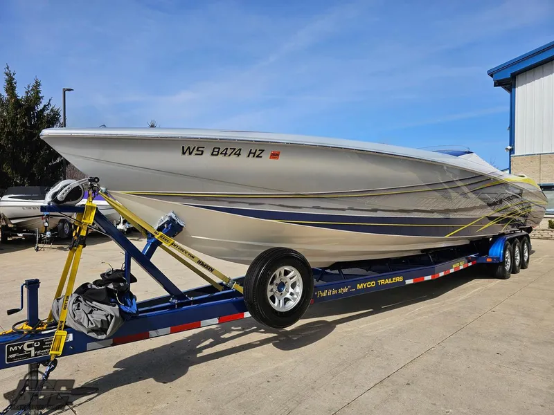 Slide: The Image of 2007 Outerlimits 39 Quattro speedboat on trailer, sleek design, parked outdoors. - 12